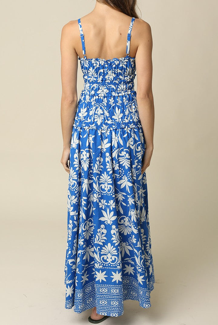 Woman wearing a blue floral dress against a beige background