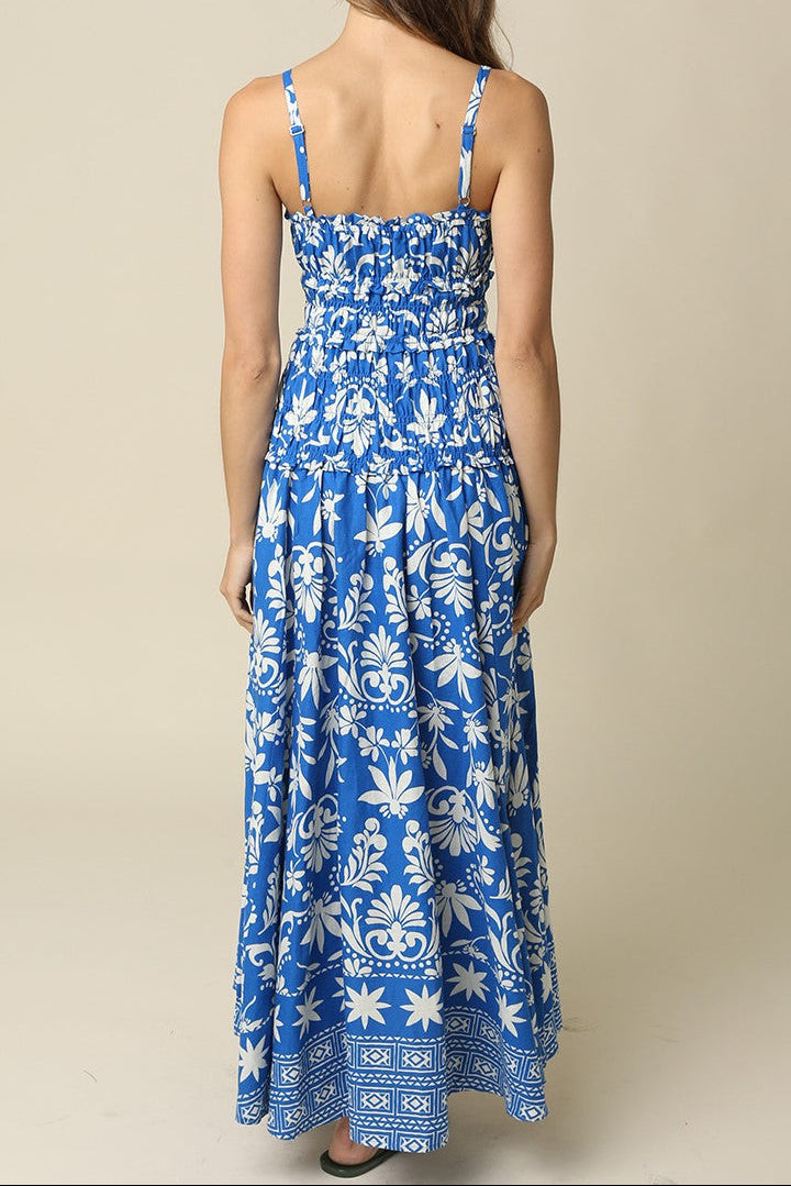 Woman wearing a blue floral dress against a beige background