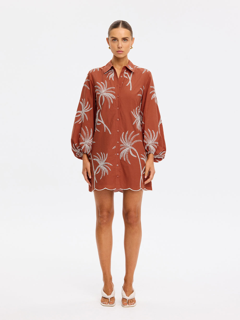 Woman wearing a brown floral dress on a white background