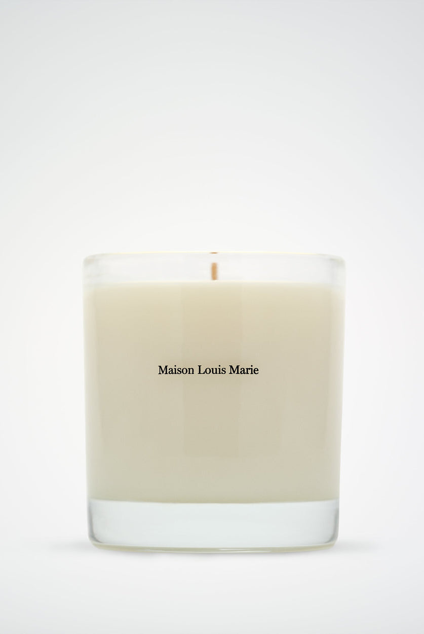 Beige candle with 'Maison Louis Marie' branding on a white background