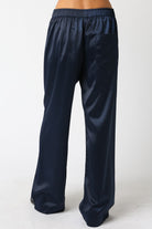 Navy blue satin pants on a white background