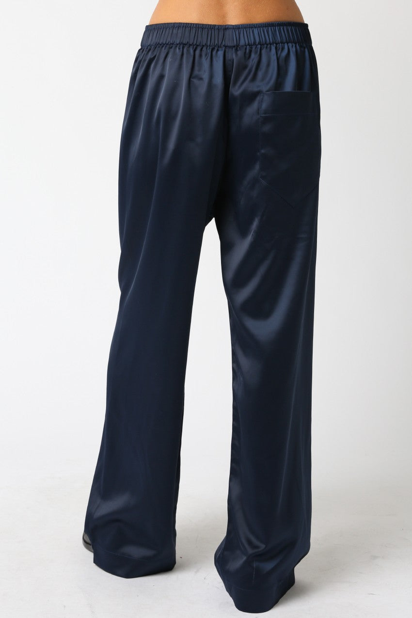 Navy blue satin pants on a white background