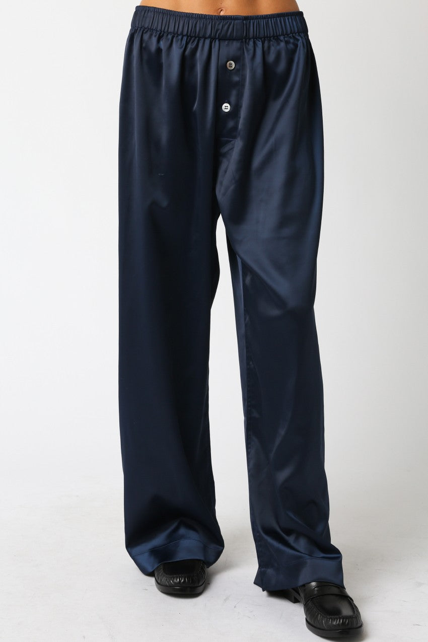 Navy blue satin pants on a white background