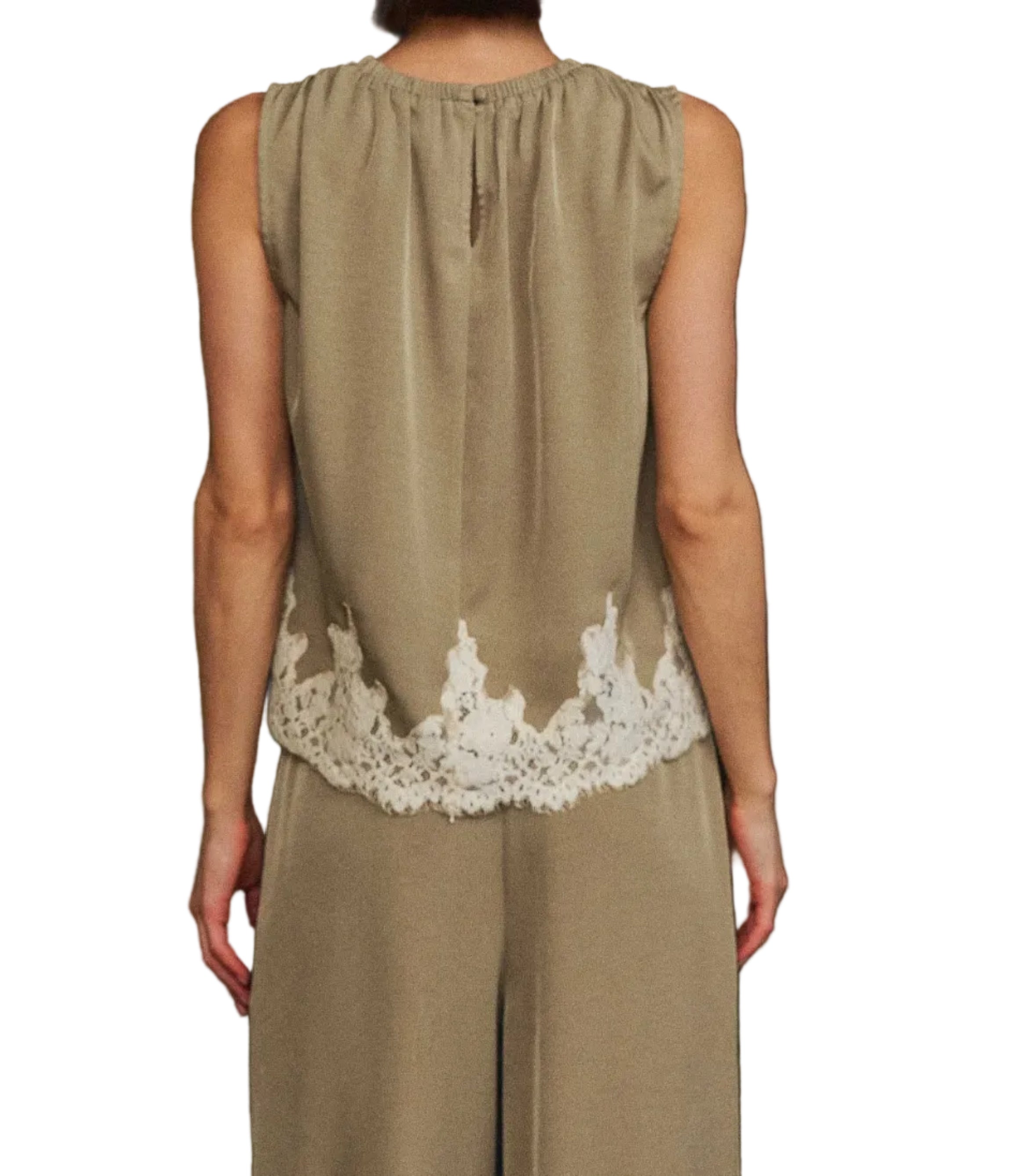 A woman viewed from behind wearing a sleeveless taupe top with a white lace hem and matching wide-leg trousers, set against a black background.
