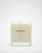 Beige candle with 'Maison Louis Marie' branding on a white background