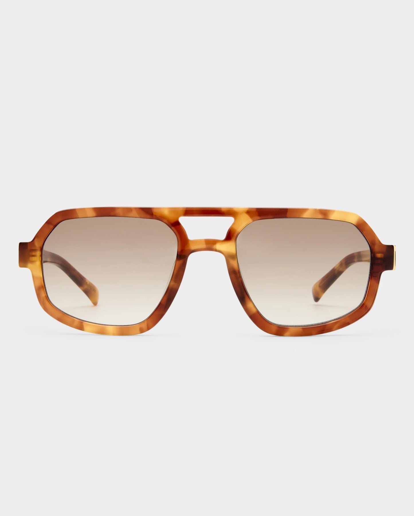 Tortoiseshell sunglasses with brown gradient lenses on a light gray background