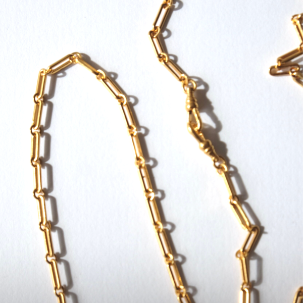 Gold chain necklace on a white background