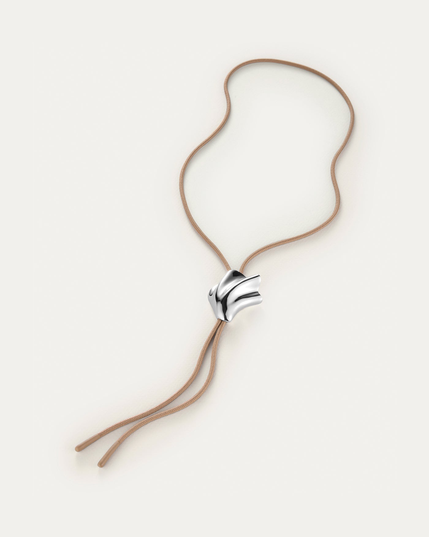 Necklace with a silver clasp on a beige background