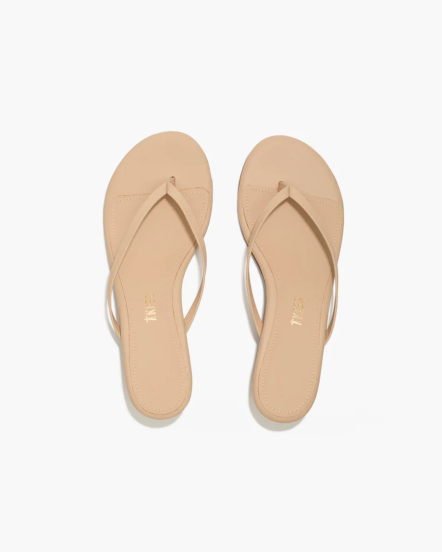 Pair of beige flip-flops on a white background