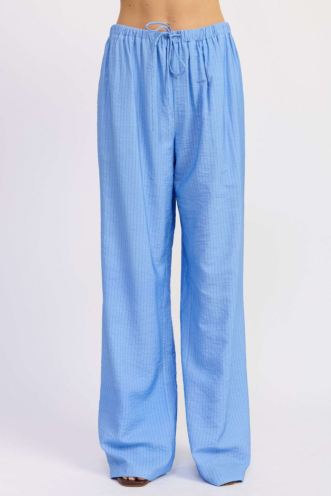 Light blue checkered pants on a white background