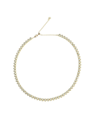 Gold necklace with clear stones on a white background