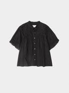 Black blouse with ruffled sleeves on a white background
